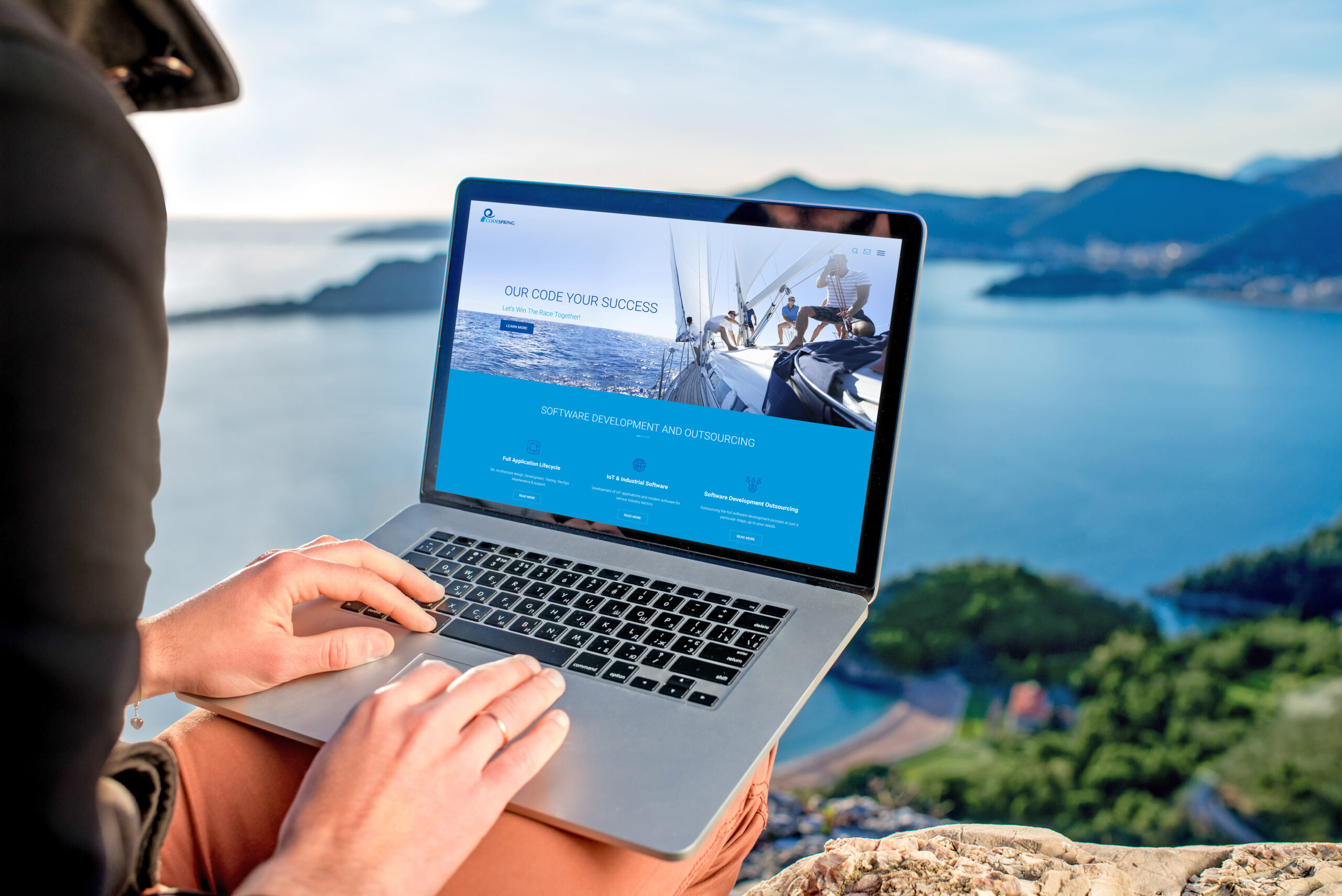 Man with laptop on the top of mountain